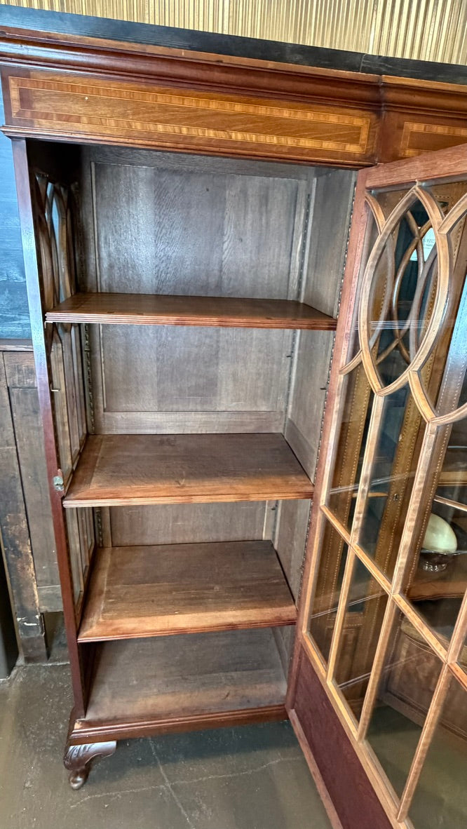 A vintage wooden display cabinet with four empty shelves, featuring a dark wood frame, glass-paneled door on the right, and a wood-grain front panel.